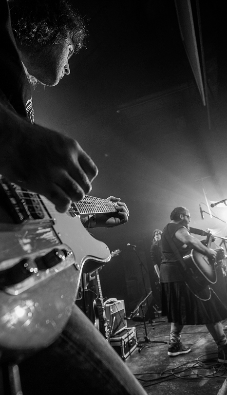 Musician playing guitar on stage